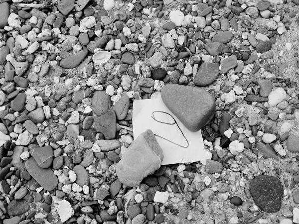 Week 18 - Number 9. A piece of paper, labeled only with "9," lies weighted down with two stones on the banks of the Rhine. What for? What does the "9" mean? A message? For whom?